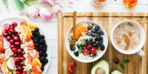black and red cherries on white bowl